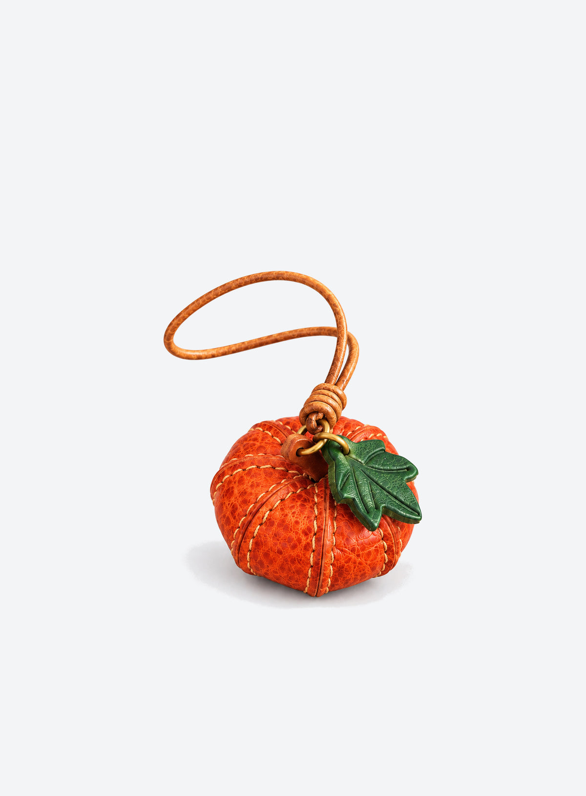 Pumpkin-shaped leather bag charm with stitched panels, a leaf accent, and a hanging loop (Pumpkin Orange)