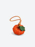Pumpkin-shaped leather bag charm with stitched panels, a leaf accent, and a hanging loop (Pumpkin Orange)