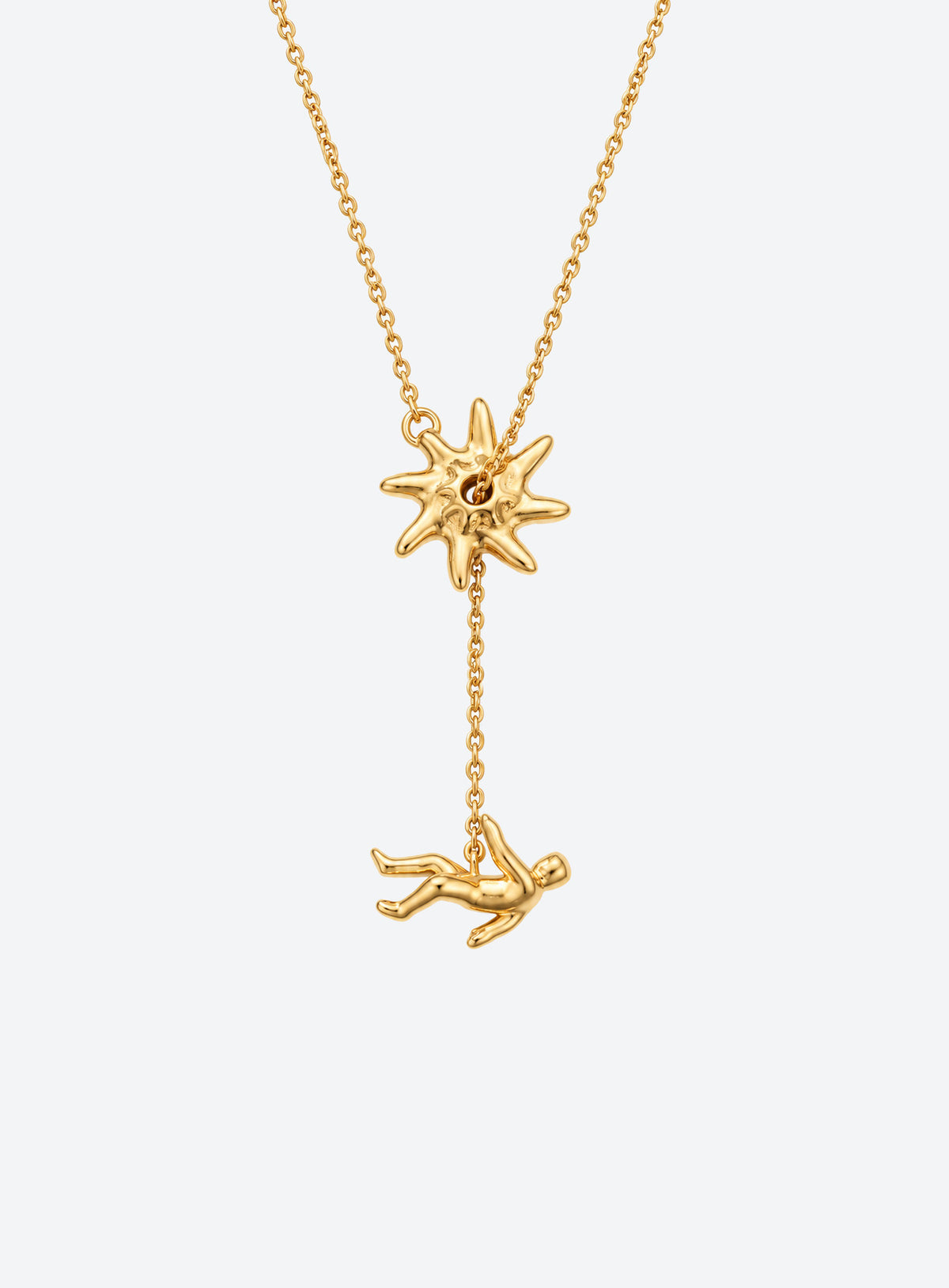 Y-shaped necklace with a hammered sunburst above a small falling figure