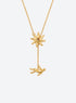 Y-shaped necklace with a hammered sunburst above a small falling figure