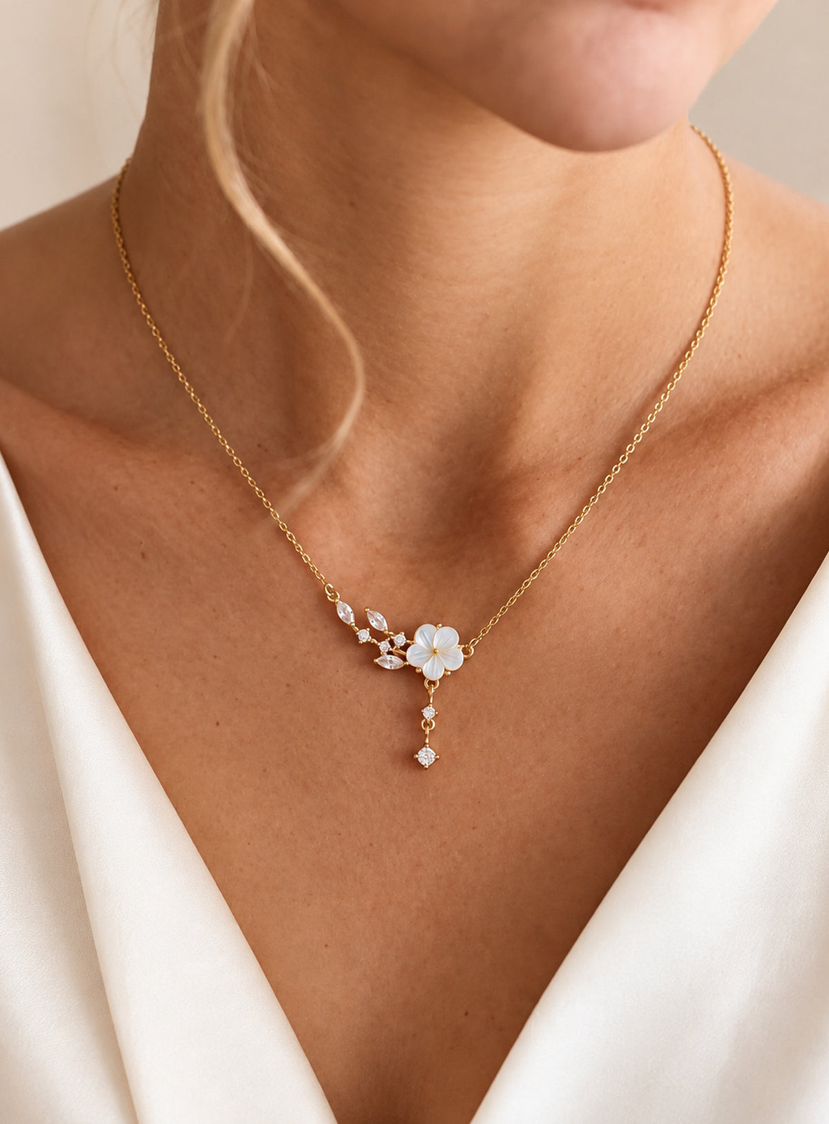 Mother of pearl flower necklace with marquise CZ leaf accents and a crystal drop