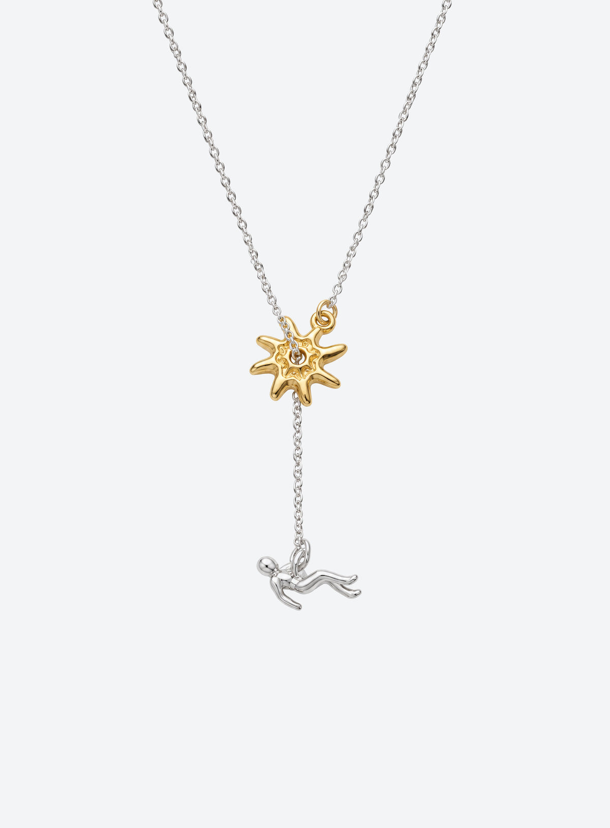Y-shaped necklace with a hammered sunburst above a small falling figure