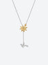 Y-shaped necklace with a hammered sunburst above a small falling figure