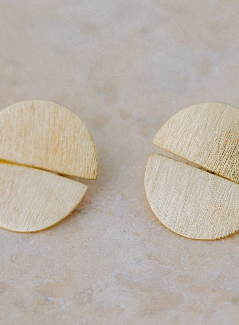 Gold half-circle earrings on a beige surface (Gold)