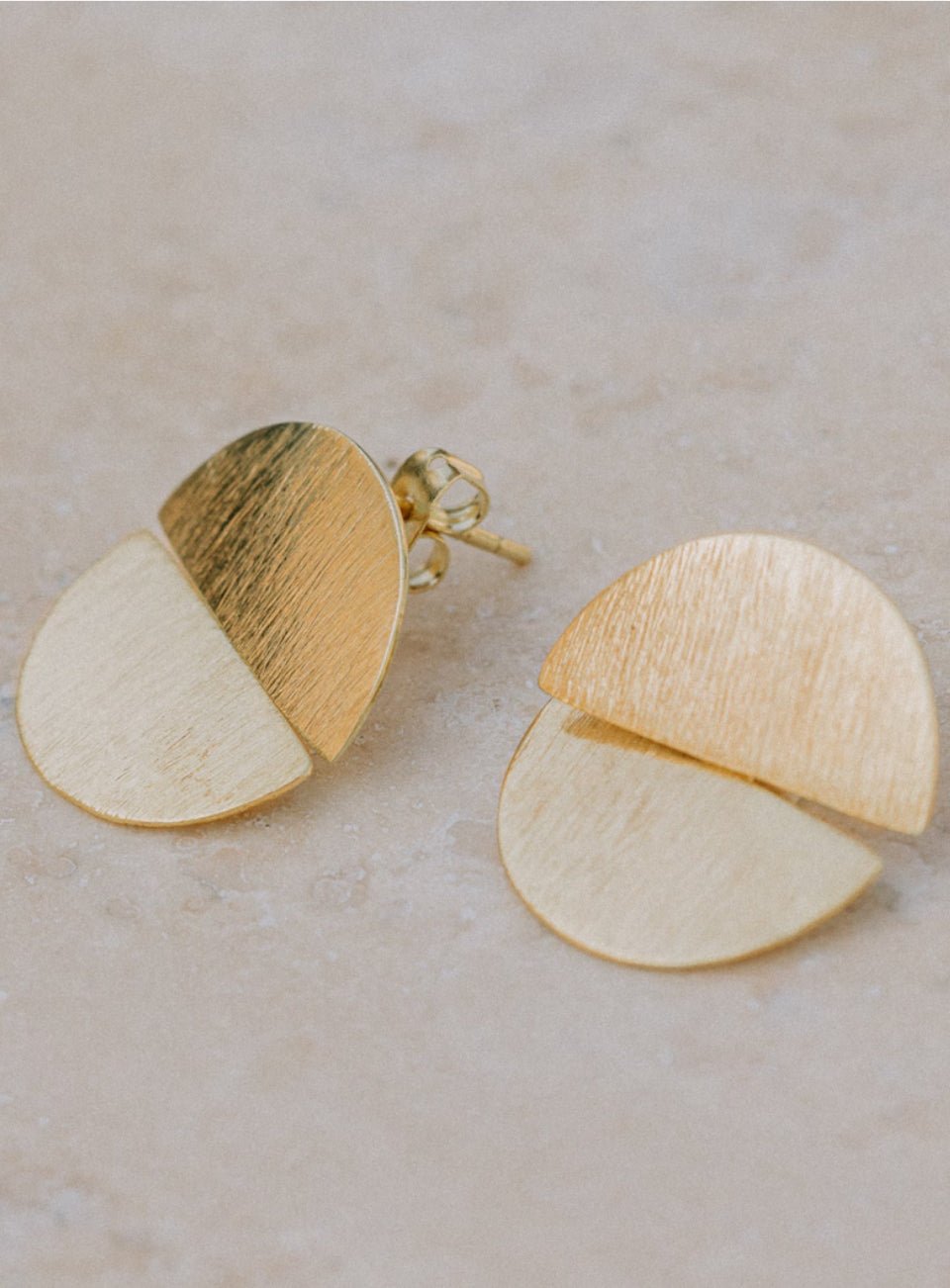 Gold and white half-circle earrings on a light beige surface (Gold)