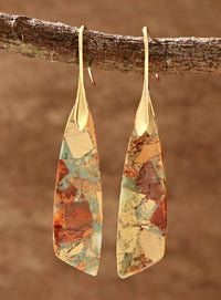 Pair of multicolored teardrop earrings hanging from a branch with a brown background (Gold)