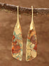 Pair of multicolored teardrop earrings hanging from a branch with a brown background (Gold)