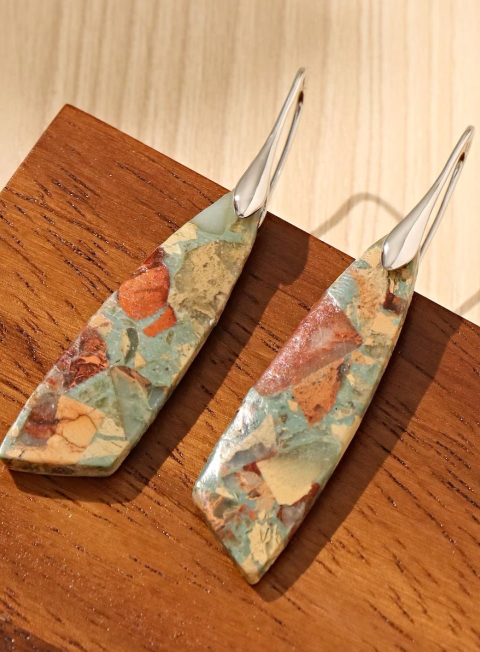 Two decorative items with floral patterns on a wooden surface (Silver)
