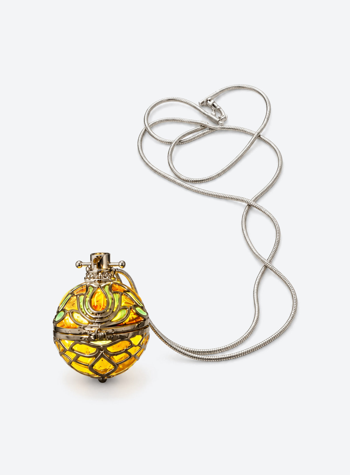 Amber-tone orb pendant necklace with silver-tone filigree cage and chain on a light studio background