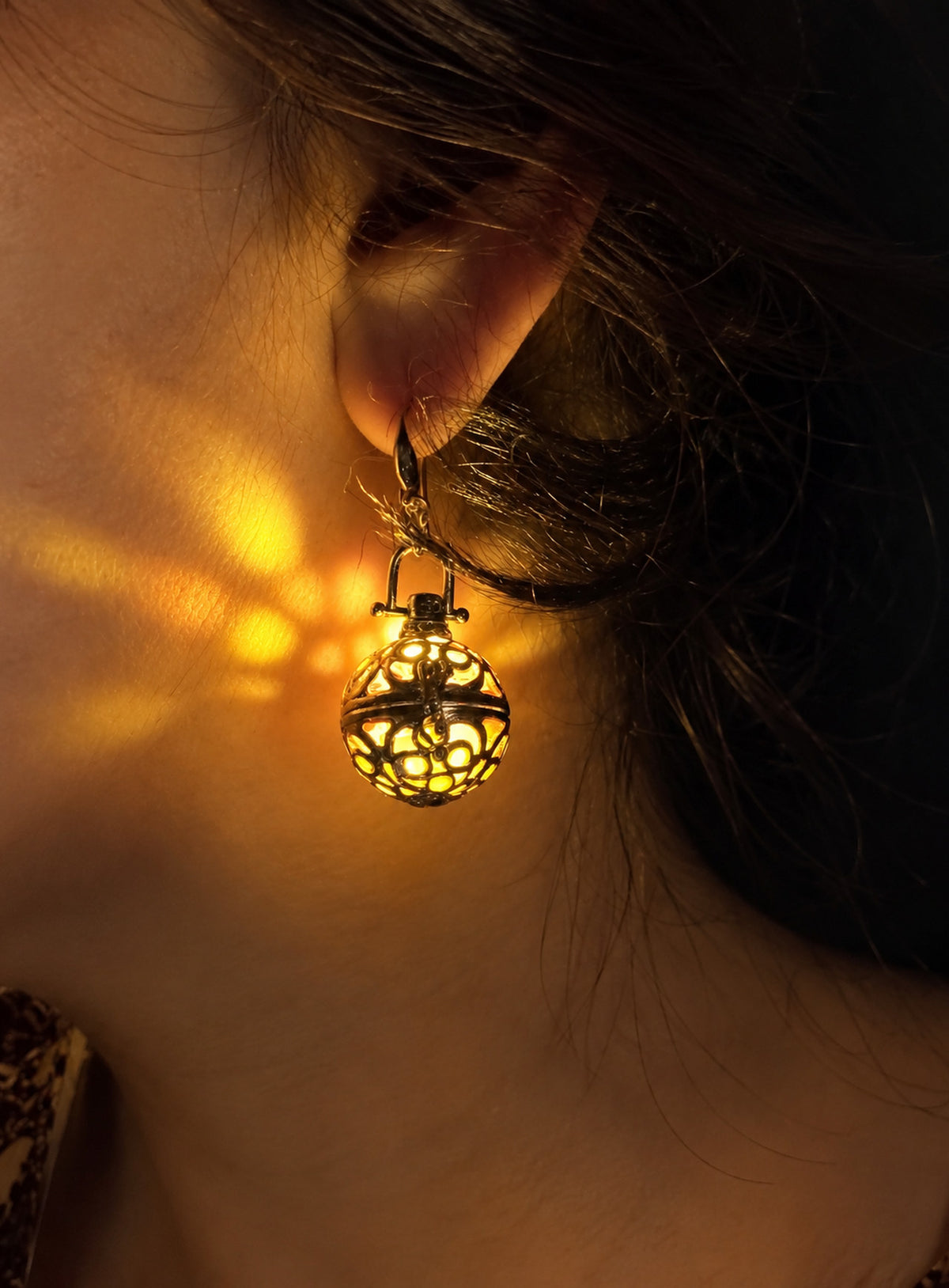 Pair of amber resin lantern earrings with silver-tone filigree cages and clear beads