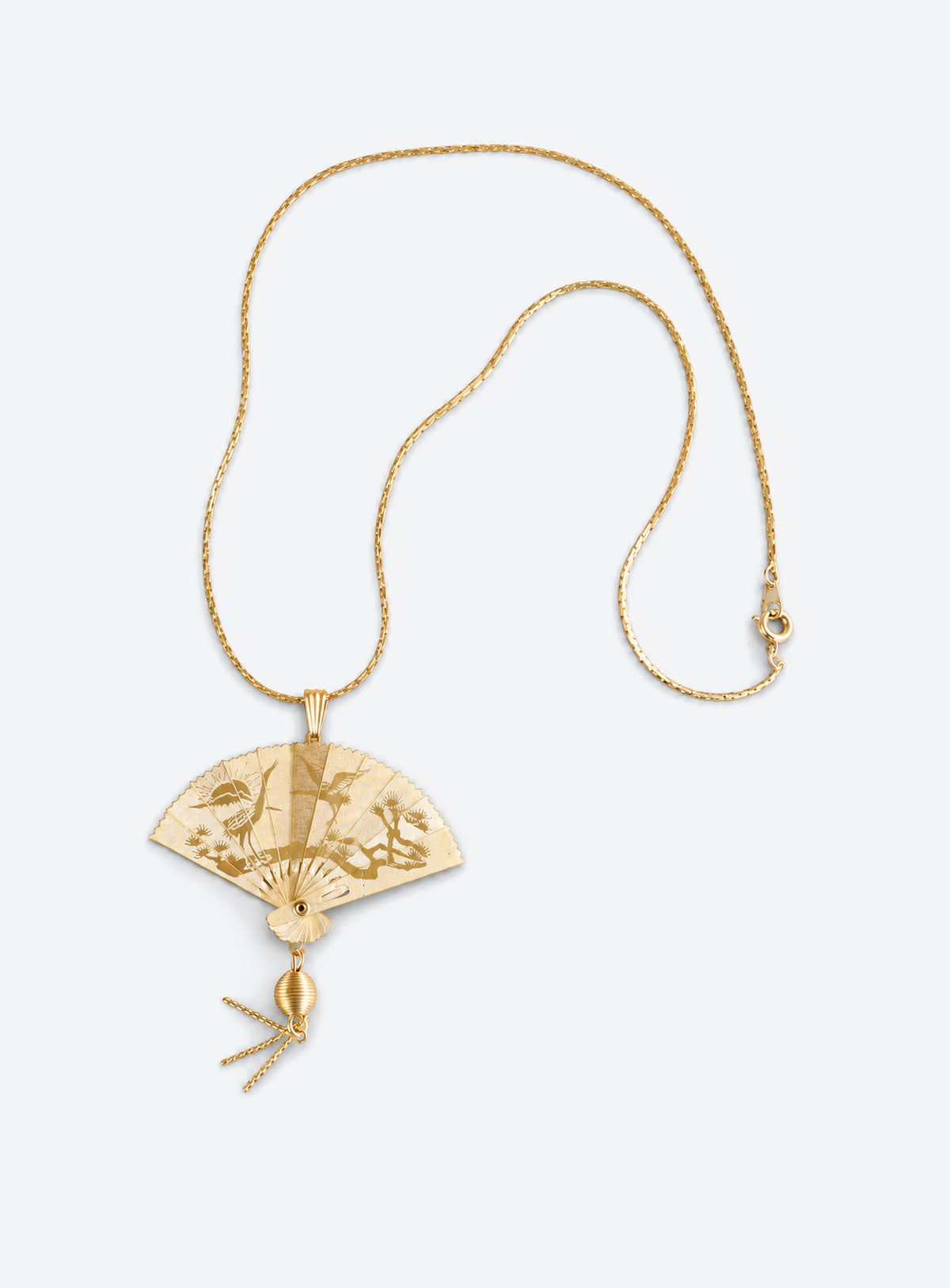 Gold-tone articulated fan pendant necklace with a crane design and matching chain