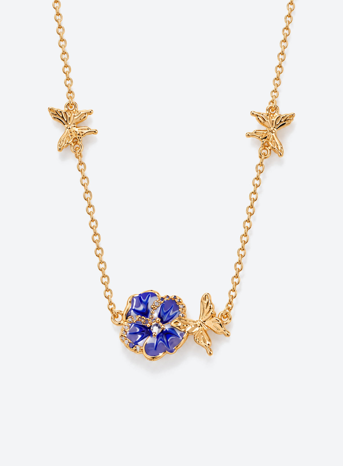 Birth flower necklace with an enamel flower centerpiece and small butterfly accents along the chain (February)