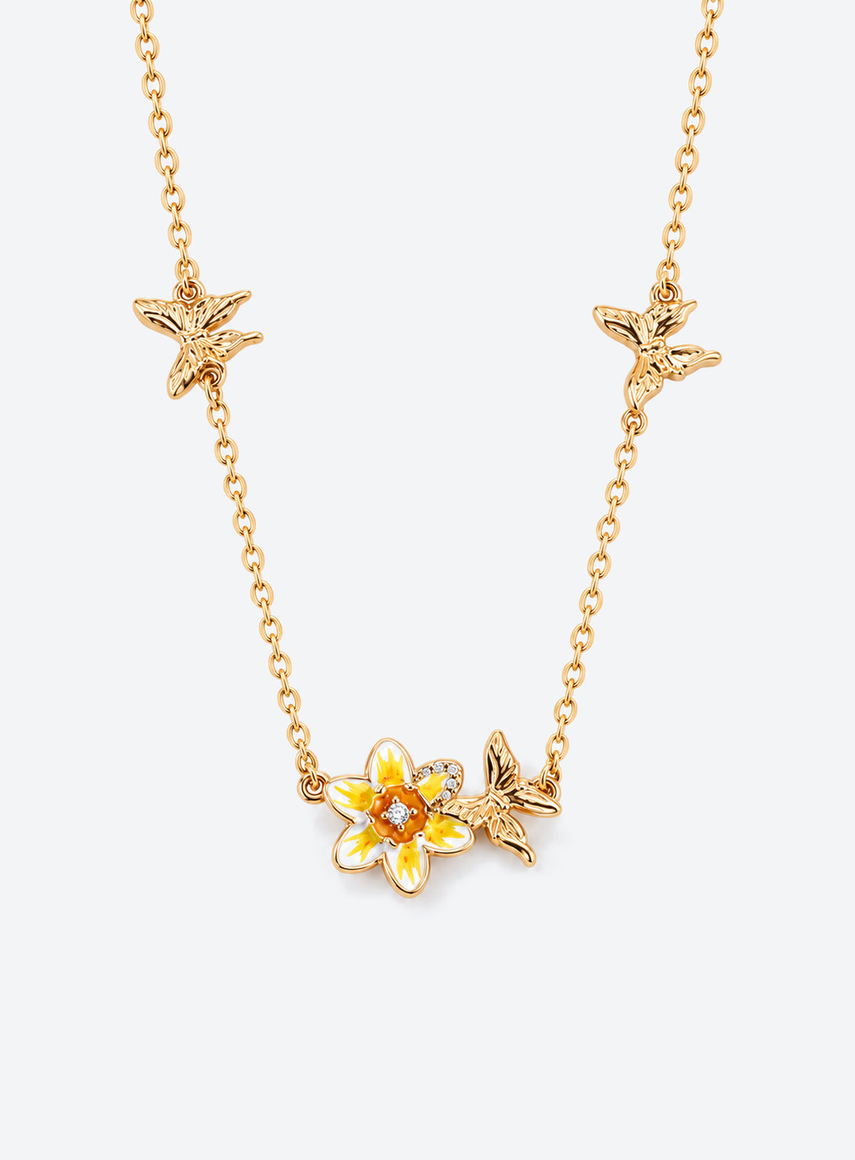 Birth flower necklace with an enamel flower centerpiece and small butterfly accents along the chain (March)
