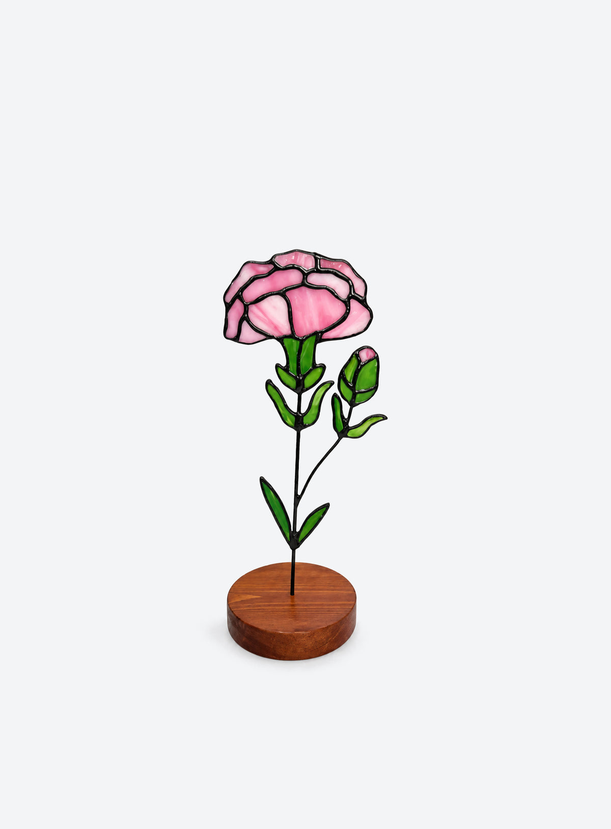 Freestanding colored-glass birth month flower with a round display base, photographed on a studio background. (January)
