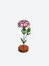 Freestanding colored-glass birth month flower with a round display base, photographed on a studio background. (January)