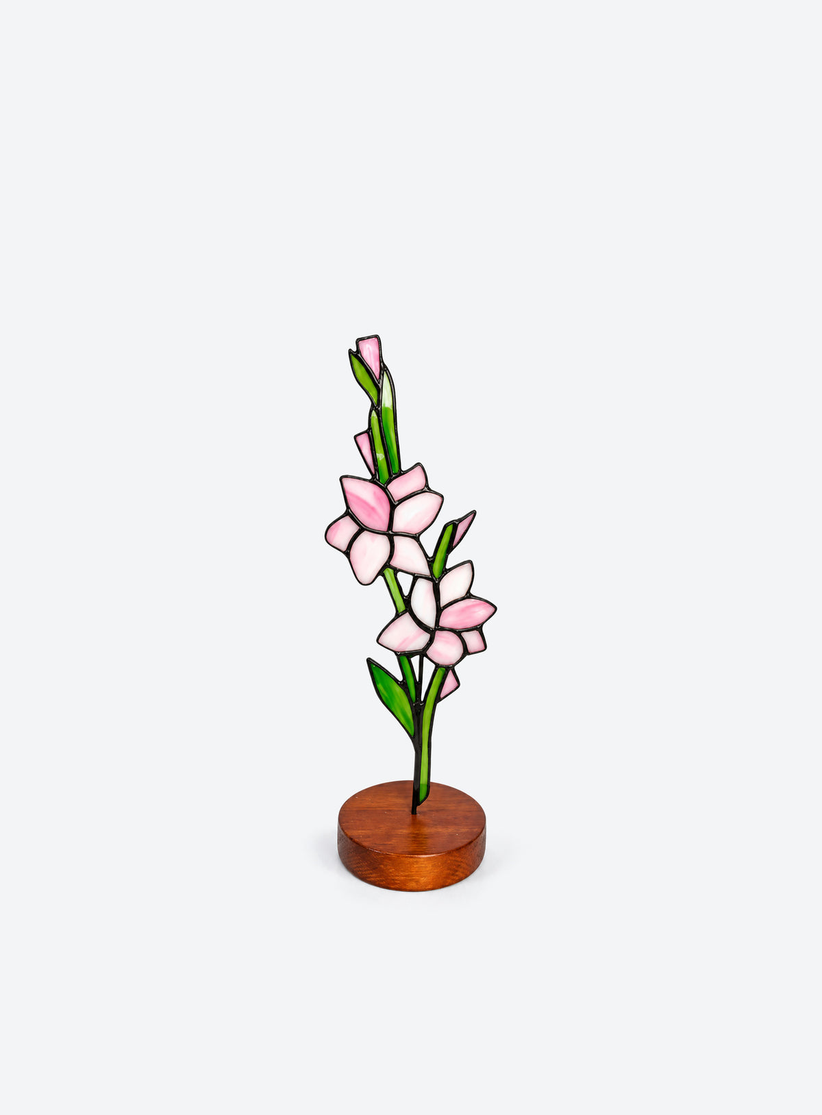 Freestanding colored-glass birth month flower with a round display base, photographed on a studio background. (August)