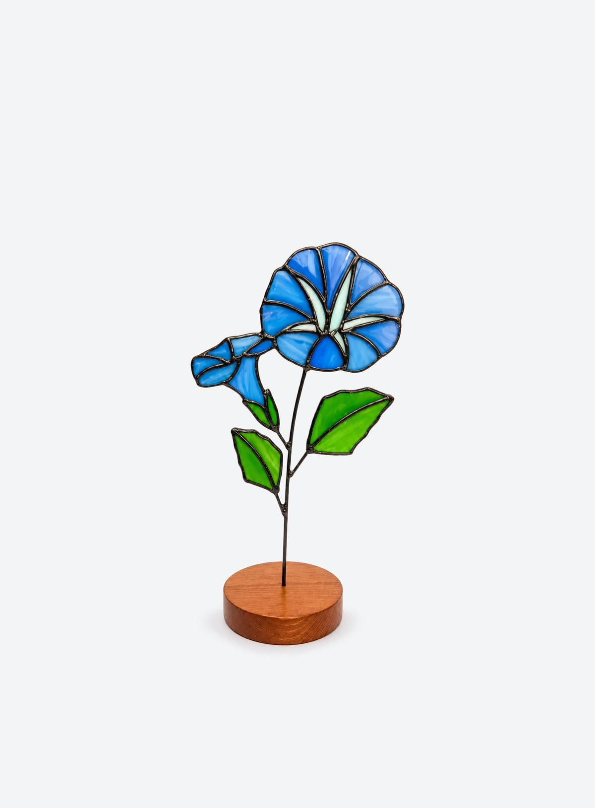 Freestanding colored-glass birth month flower with a round display base, photographed on a studio background. (September)