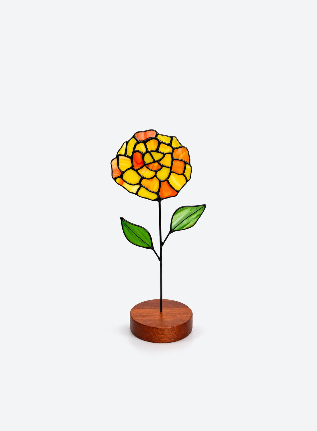 Freestanding colored-glass birth month flower with a round display base, photographed on a studio background. (October)