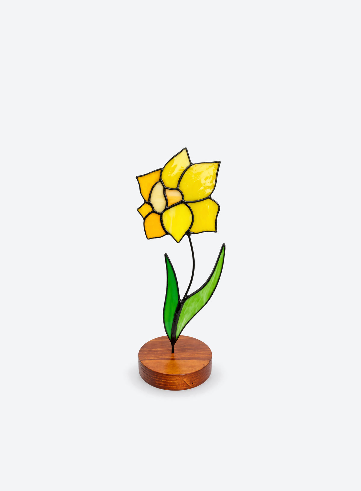 Freestanding colored-glass birth month flower with a round display base, photographed on a studio background. (March)