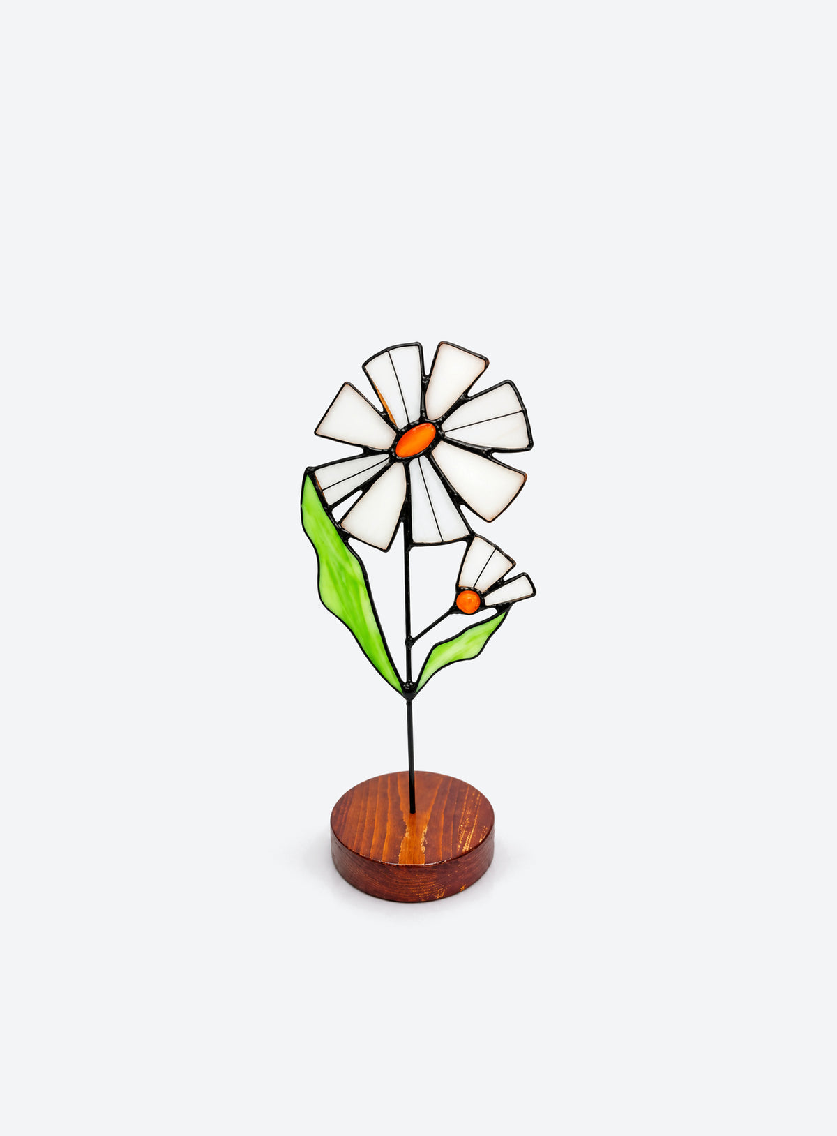 Freestanding colored-glass birth month flower with a round display base, photographed on a studio background. (April)