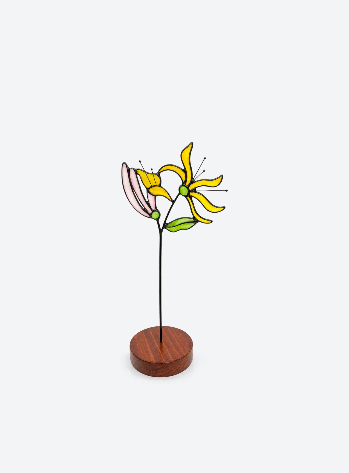 Freestanding colored-glass birth month flower with a round display base, photographed on a studio background. (June)