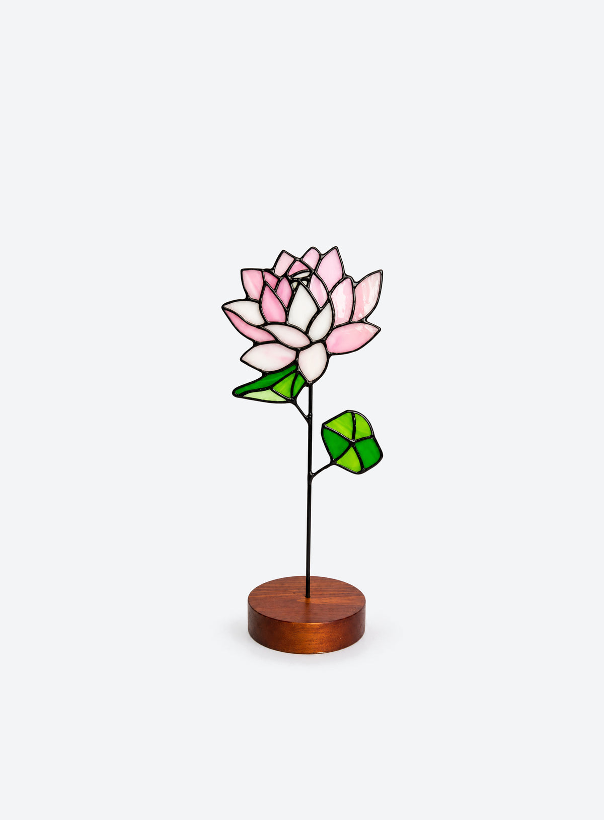 Freestanding colored-glass birth month flower with a round display base, photographed on a studio background. (July)