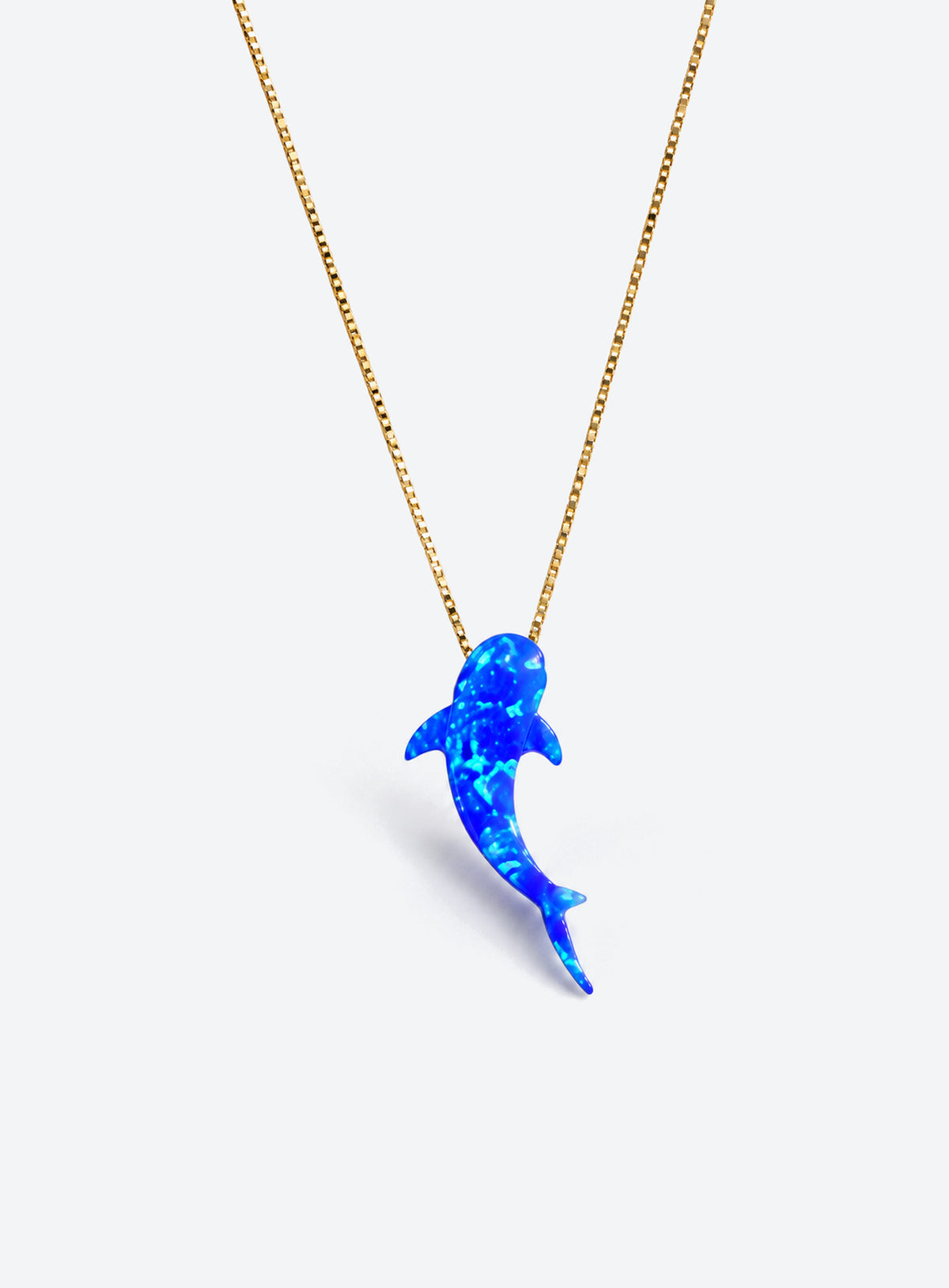 Blue synthetic-opal whale shark pendant on a gold-tone box chain