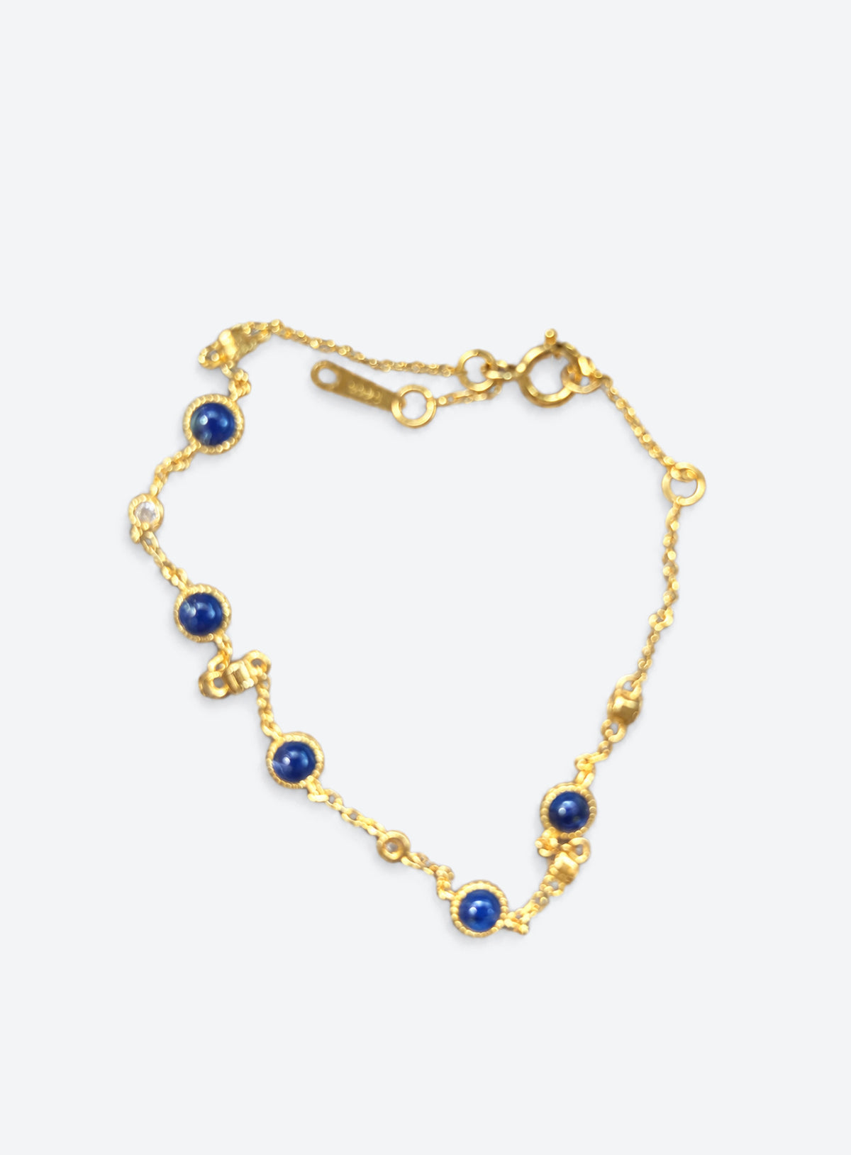Blue and clear stone station bracelet with round settings and a delicate adjustable chain (Gold)