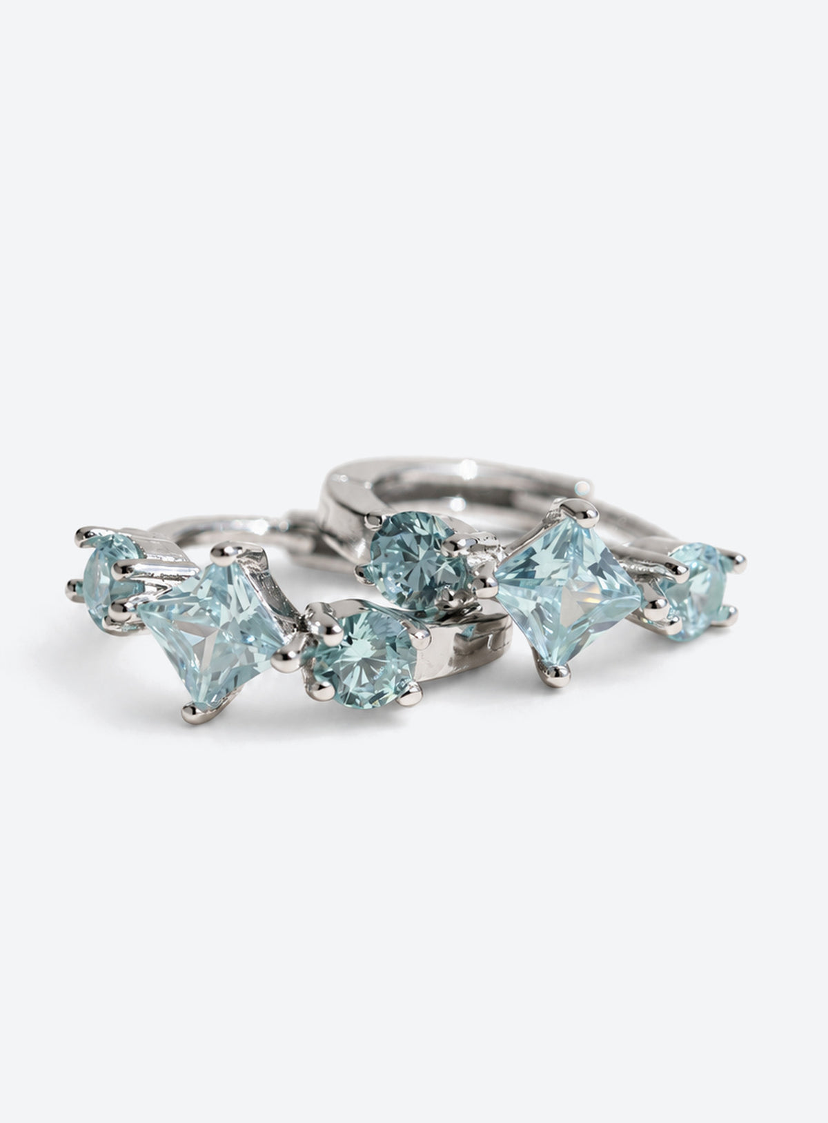 Small hoop earrings with pale blue round and diamond-shaped stones