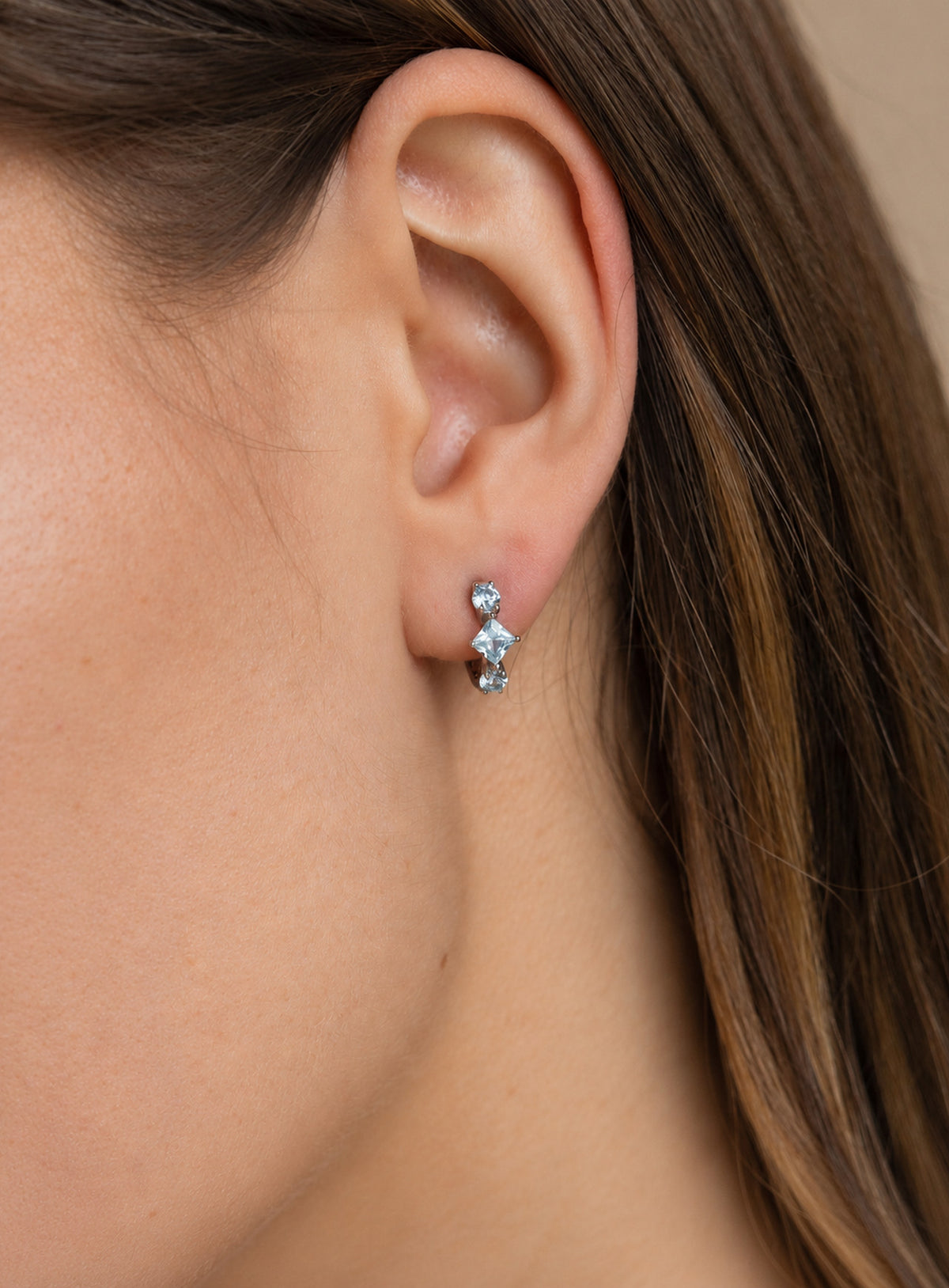Small hoop earrings with pale blue round and diamond-shaped stones