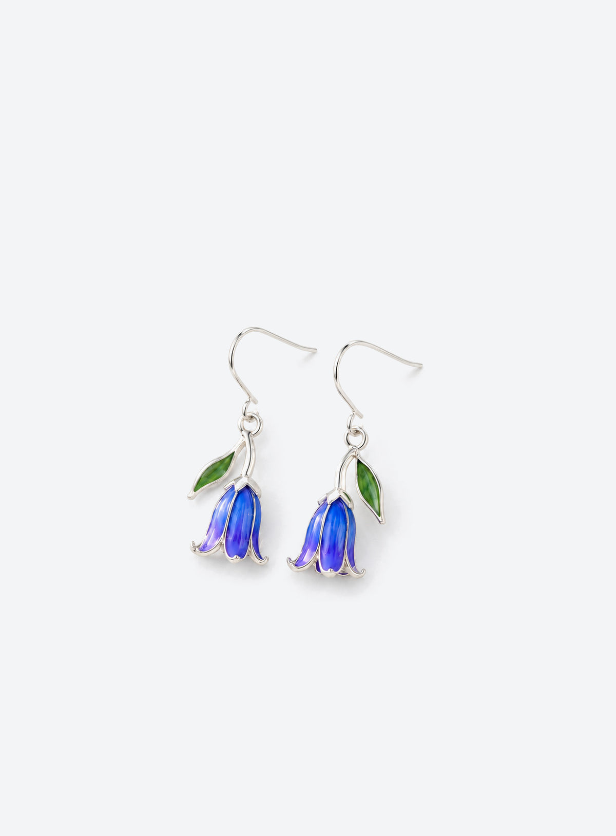 Blue and purple bell-shaped flower drop earrings with green leaves and silver-tone hooks