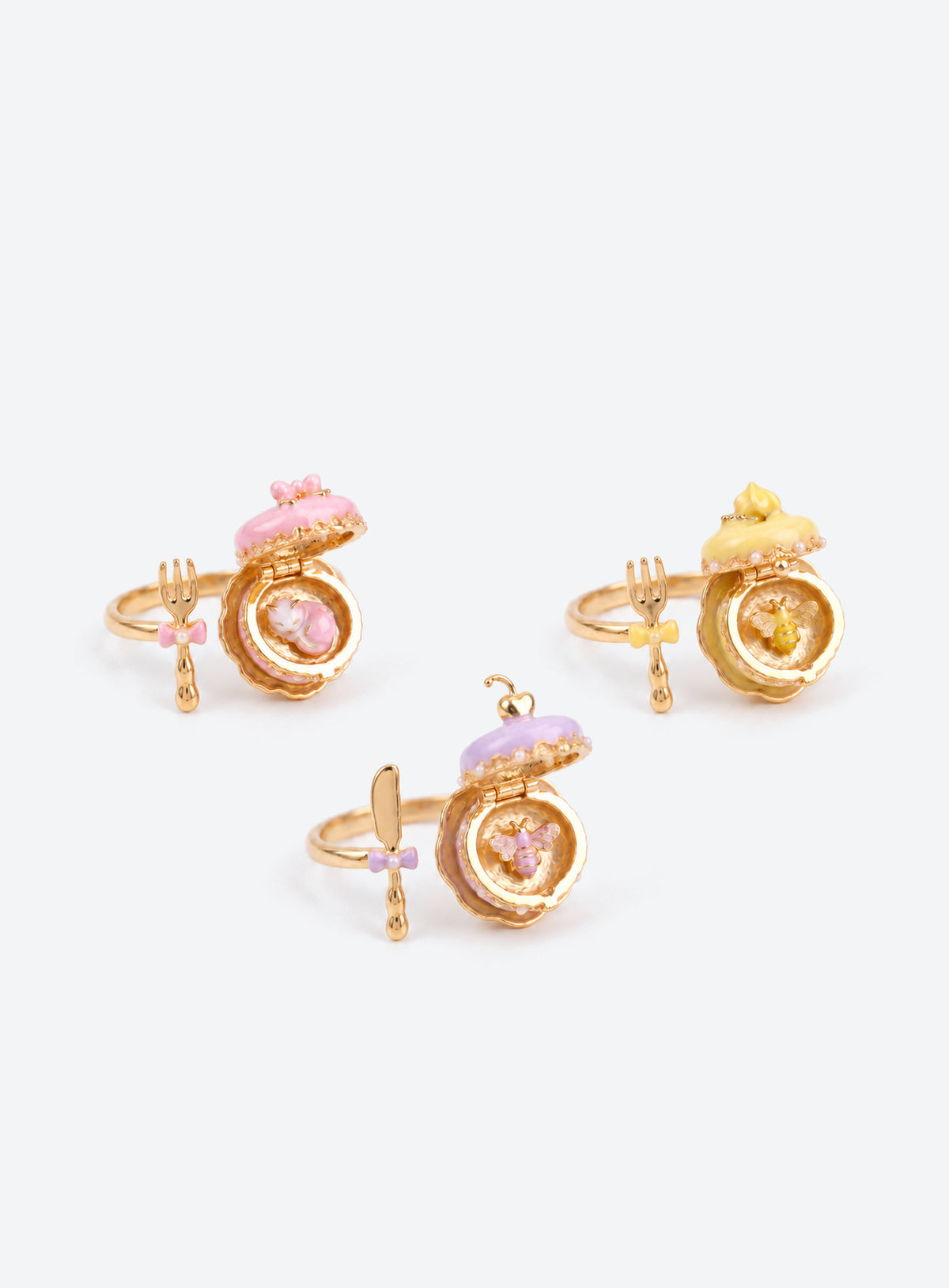 Cake-shaped locket ring with enamel details, gold-tone trim, an open band and a miniature cutlery charm