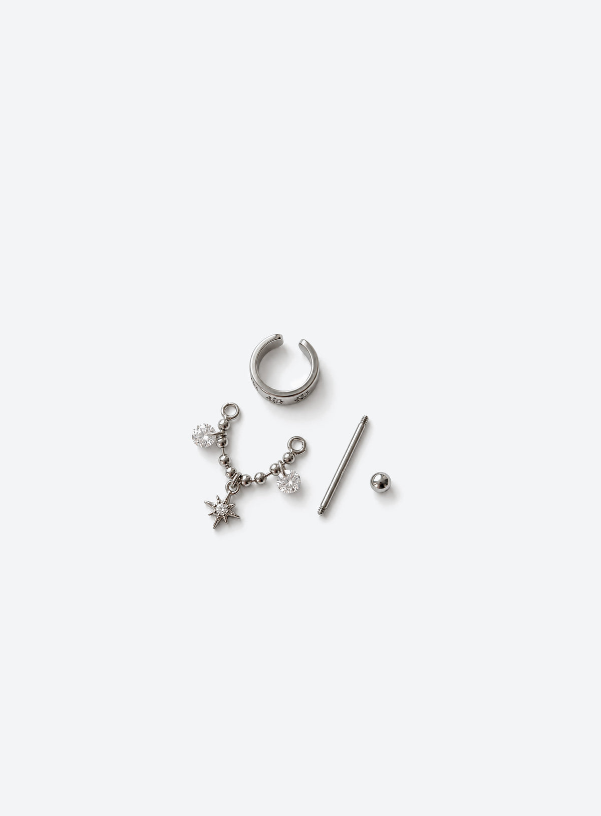Curved celestial cartilage stud with star motifs, a beaded chain, two clear stone drops, and a dangling star