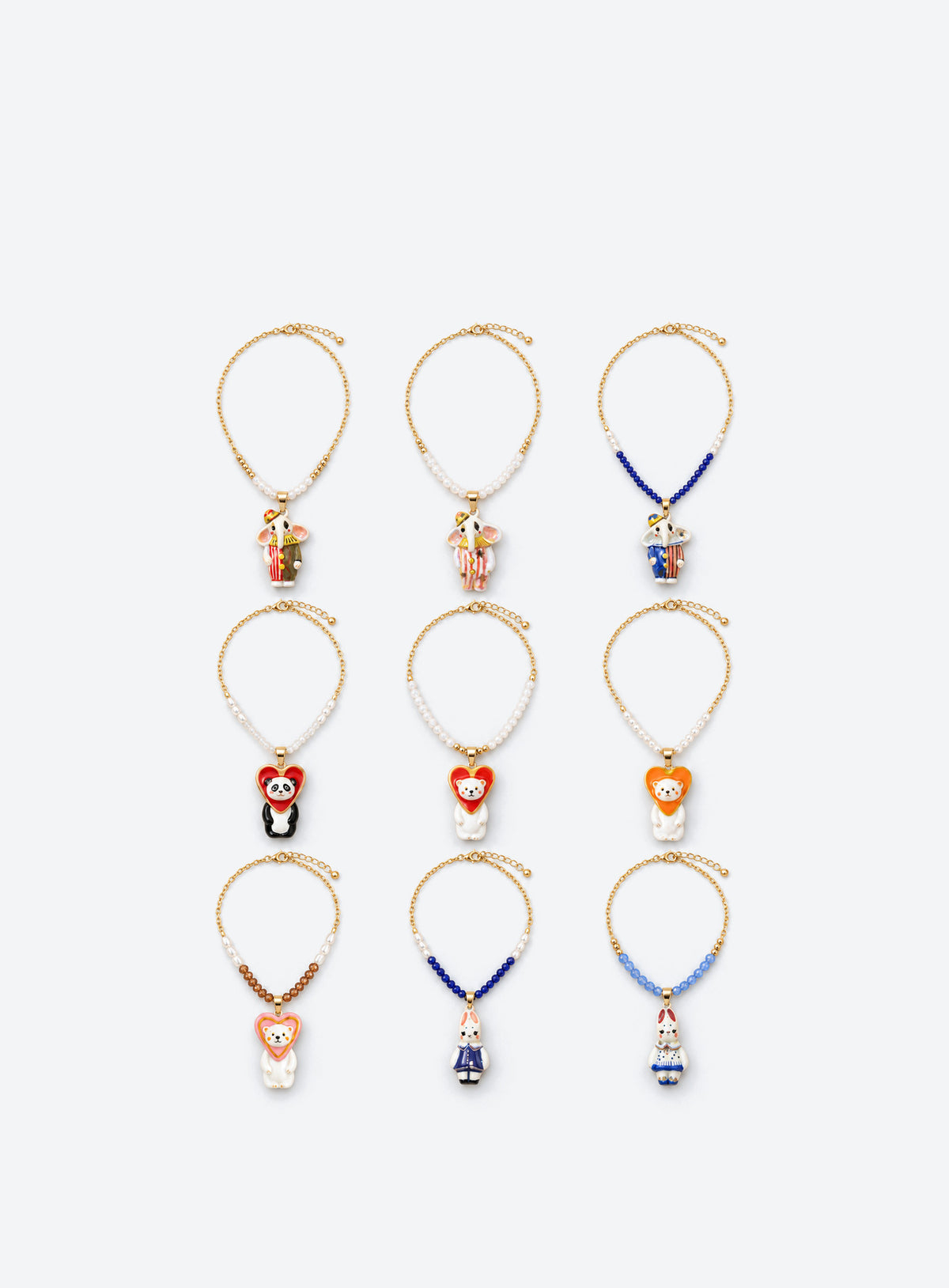 Hand-painted ceramic animal pendant necklace with gold-tone detailing and small colored beads on a delicate chain