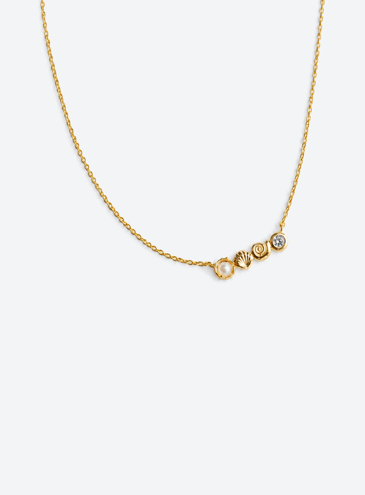 Delicate necklace with conch and scallop shell charms, a faux pearl and clear accents (Gold)