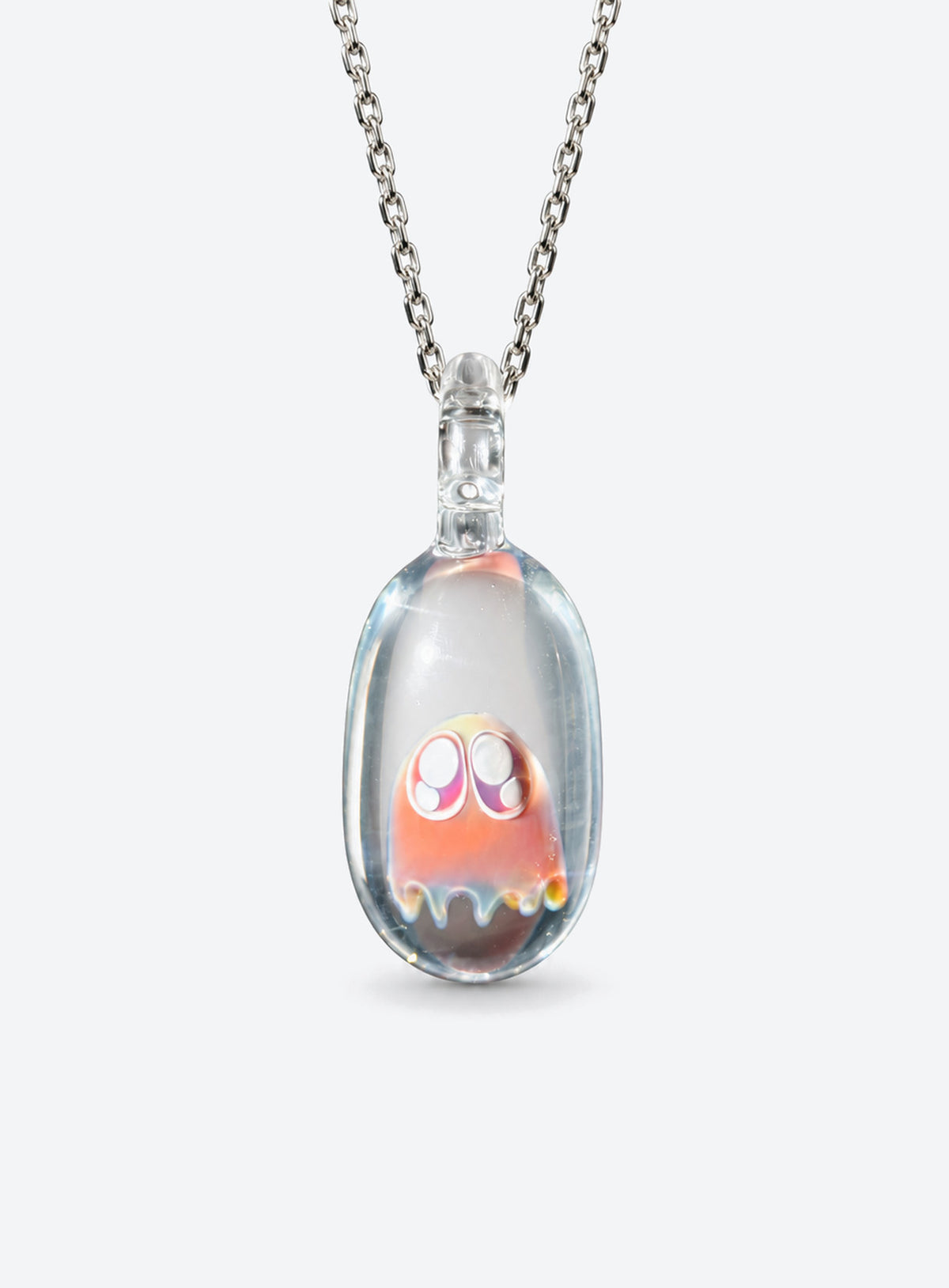 Rounded clear glass ghost pendant with large outlined eyes, small pale highlights, and a silver-tone chain