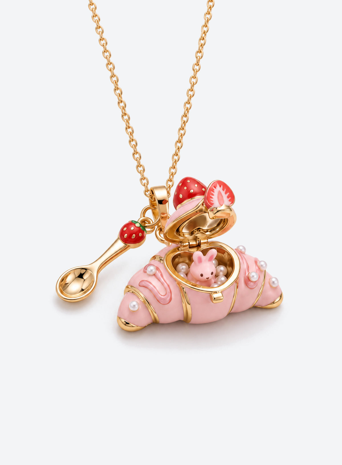 Croissant-shaped enamel locket necklace with an animal figurine inside, a fine chain, and a small cutlery charm (Rabbit)