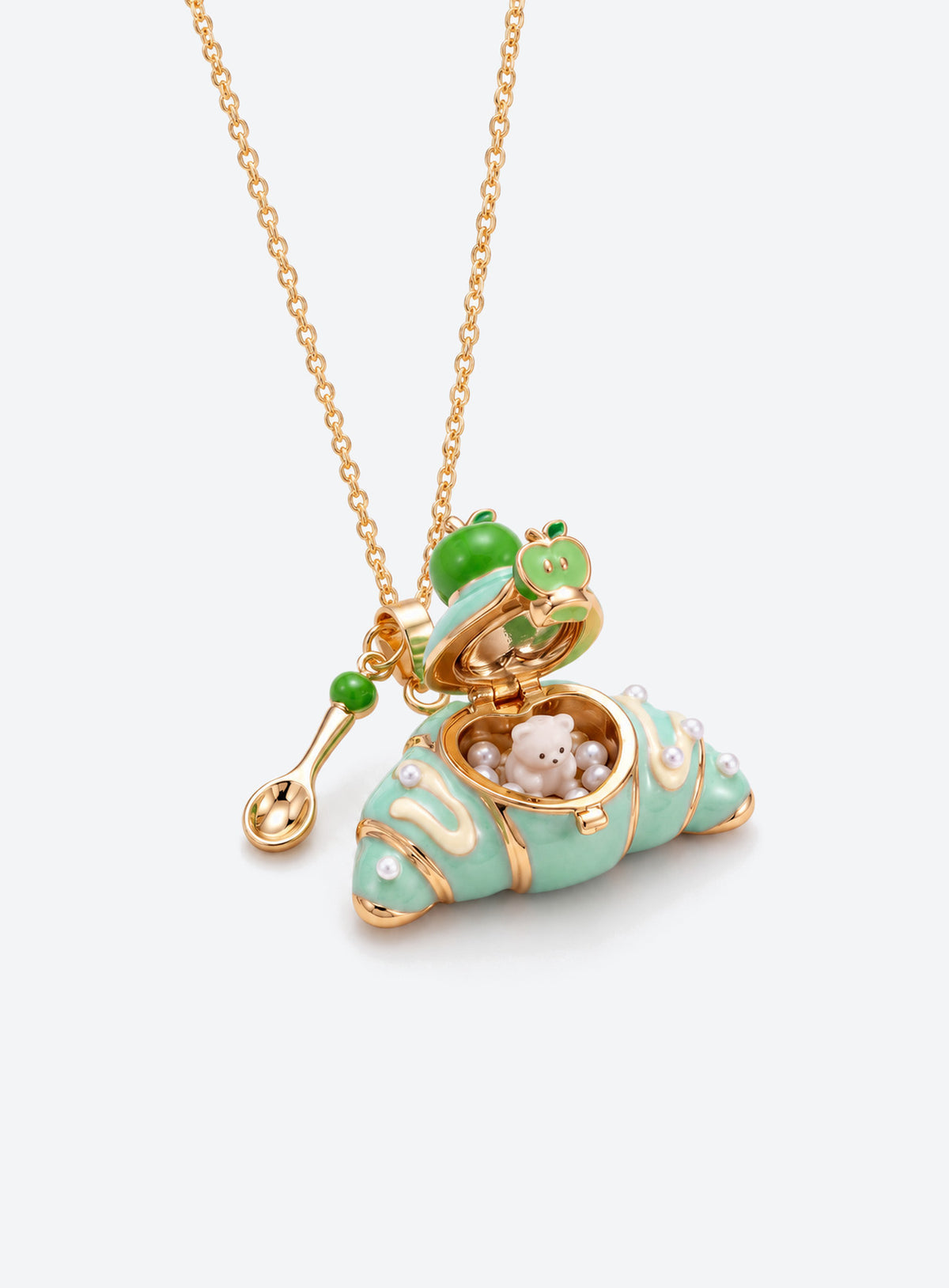 Croissant-shaped enamel locket necklace with an animal figurine inside, a fine chain, and a small cutlery charm (Bear)