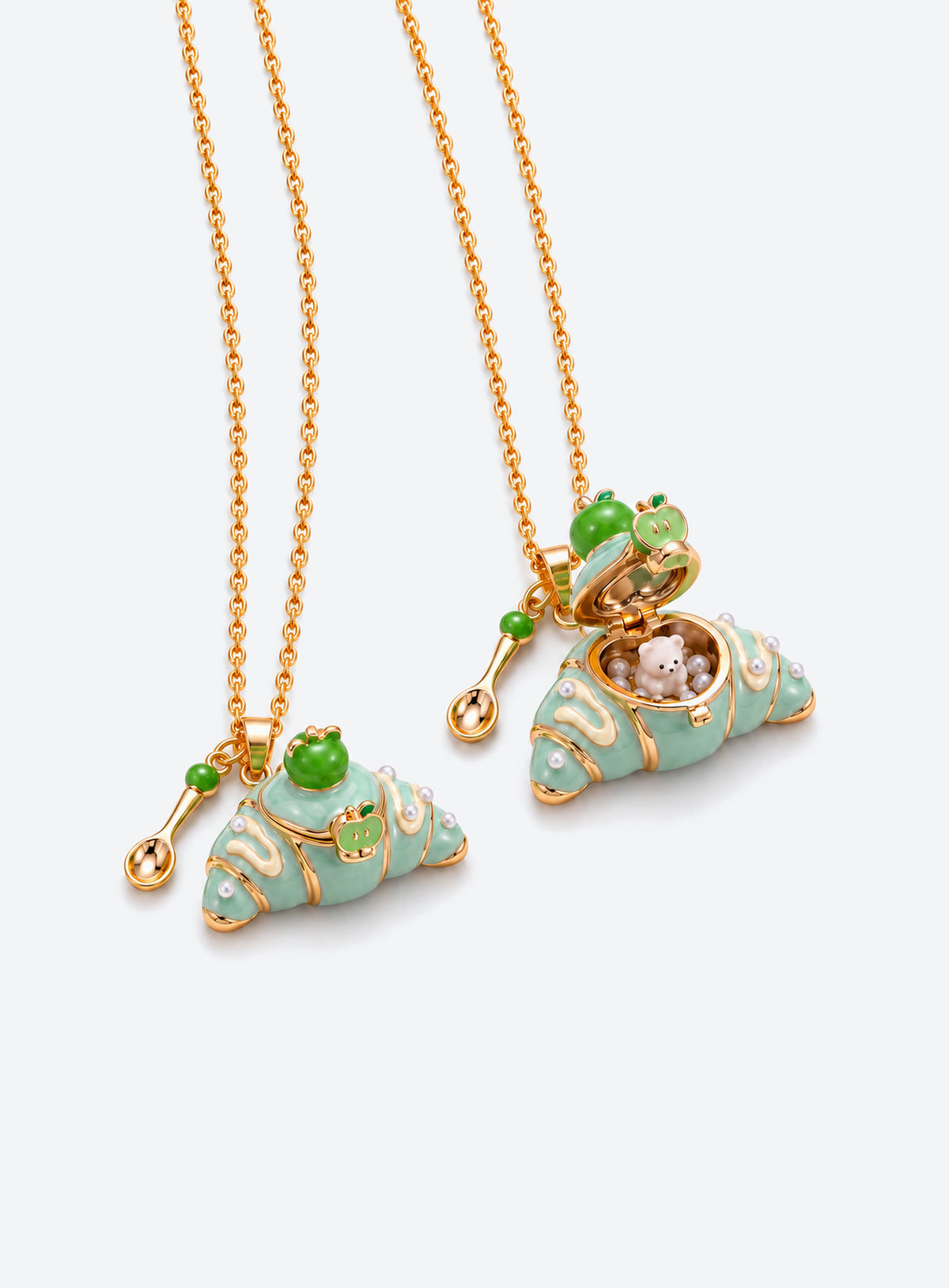 Croissant-shaped enamel locket necklace with an animal figurine inside, a fine chain, and a small cutlery charm (Bear)