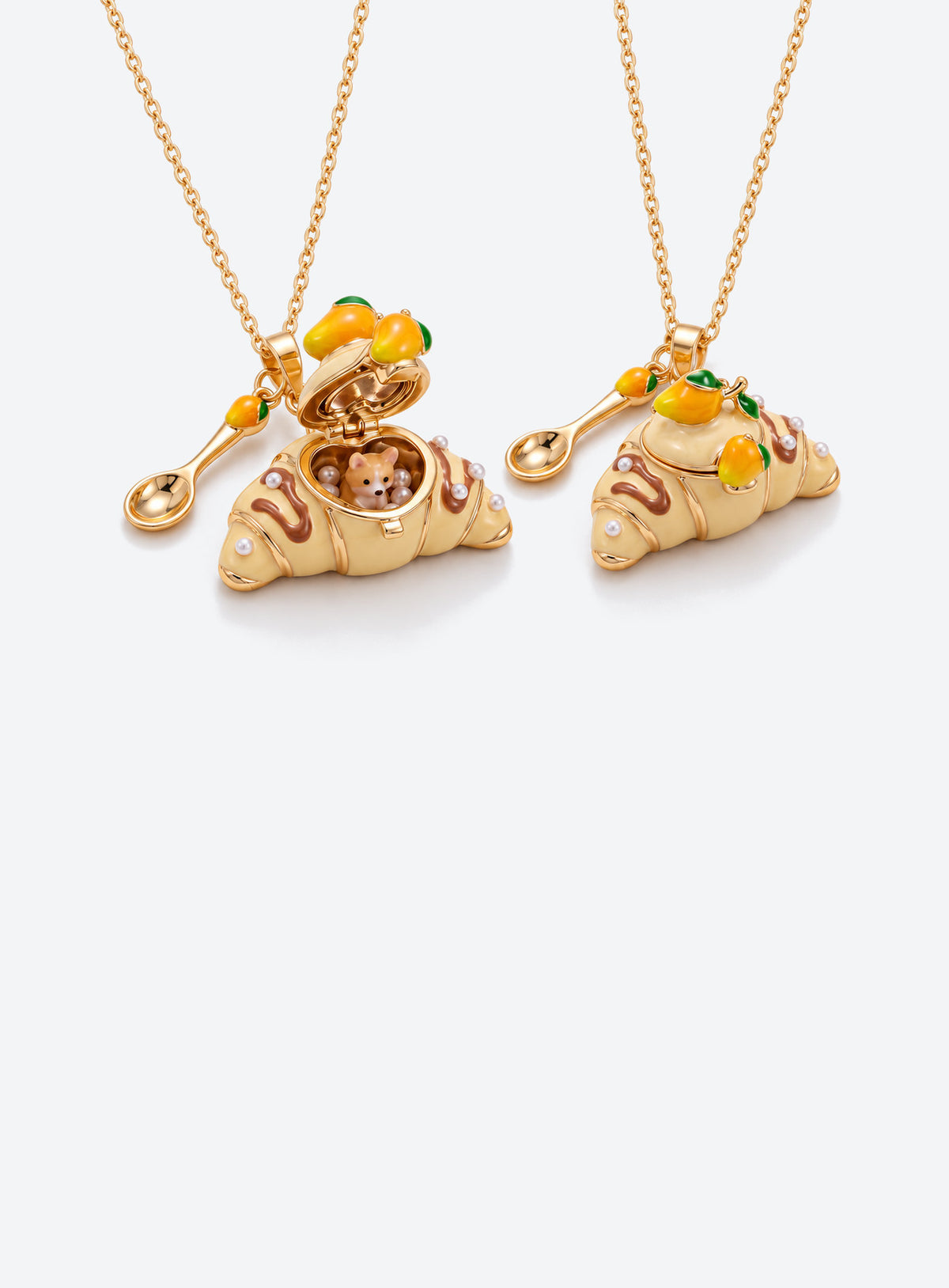 Croissant-shaped enamel locket necklace with an animal figurine inside, a fine chain, and a small cutlery charm (Corgi)