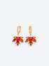 Gold tone earrings with red orange crystal maple leaf pendants