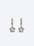 Silver-tone stone-set huggie hoops with clear asymmetrical five-point star drops and small crystal accents