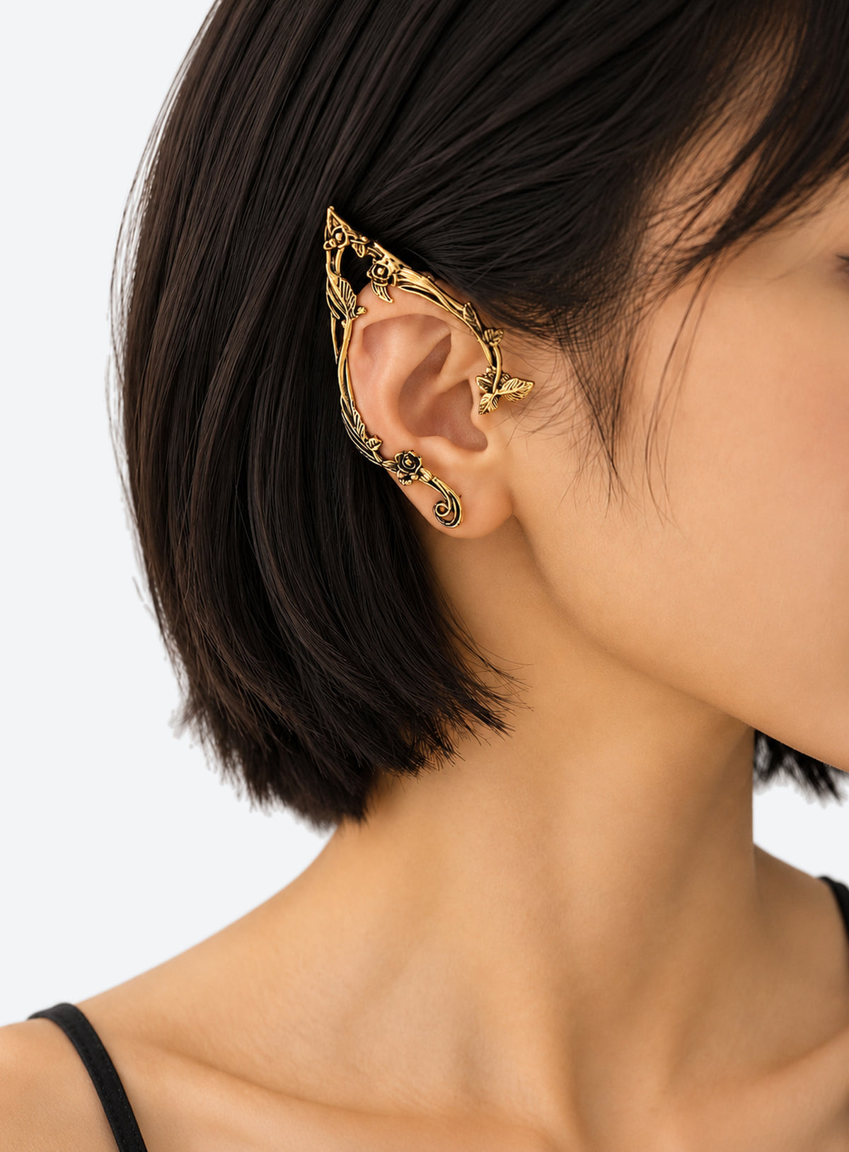Gold-color mirrored pair of elf-inspired ear cuffs with flower, leaf, and vine details.