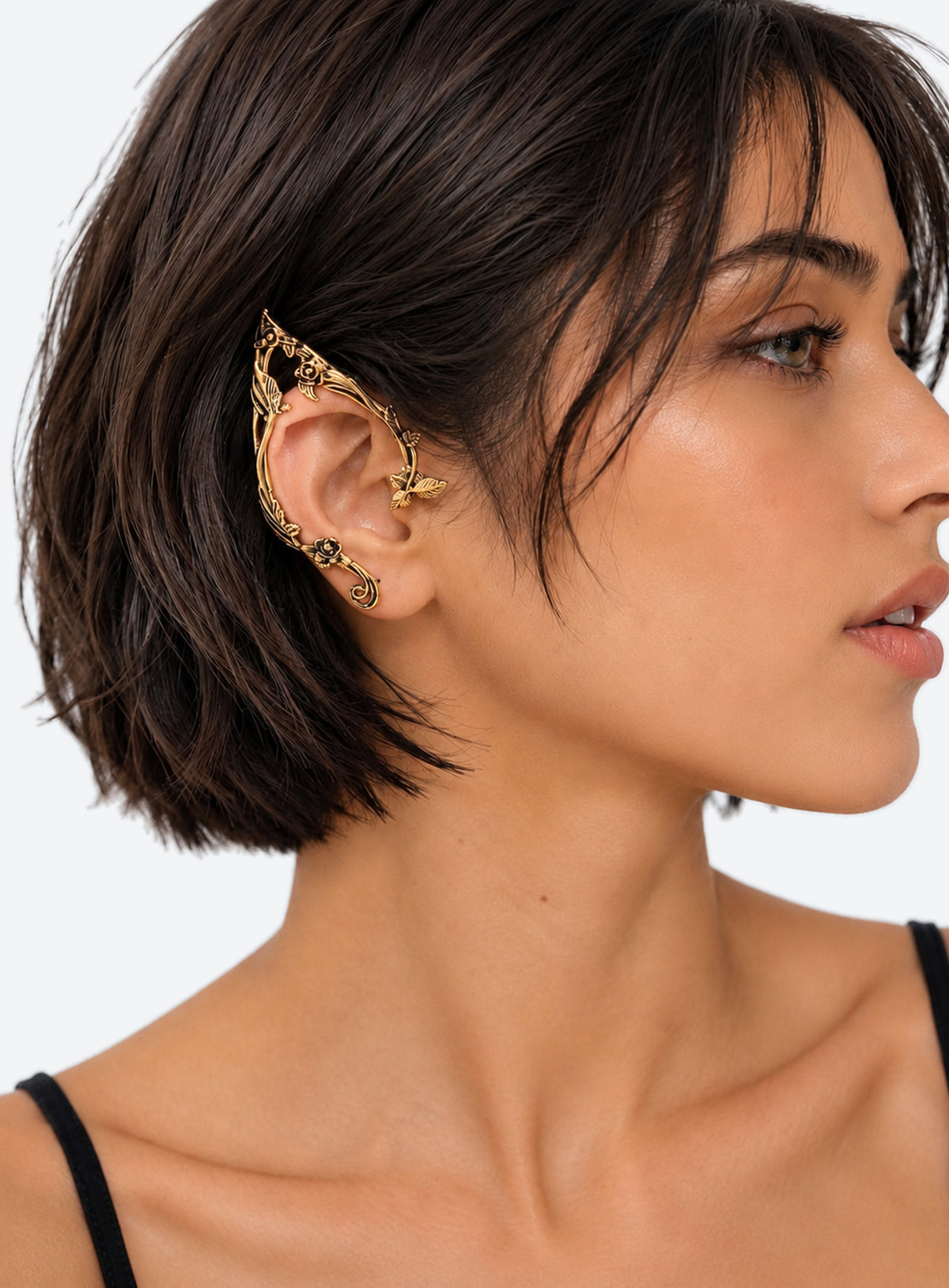 Gold-color mirrored pair of elf-inspired ear cuffs with flower, leaf, and vine details.