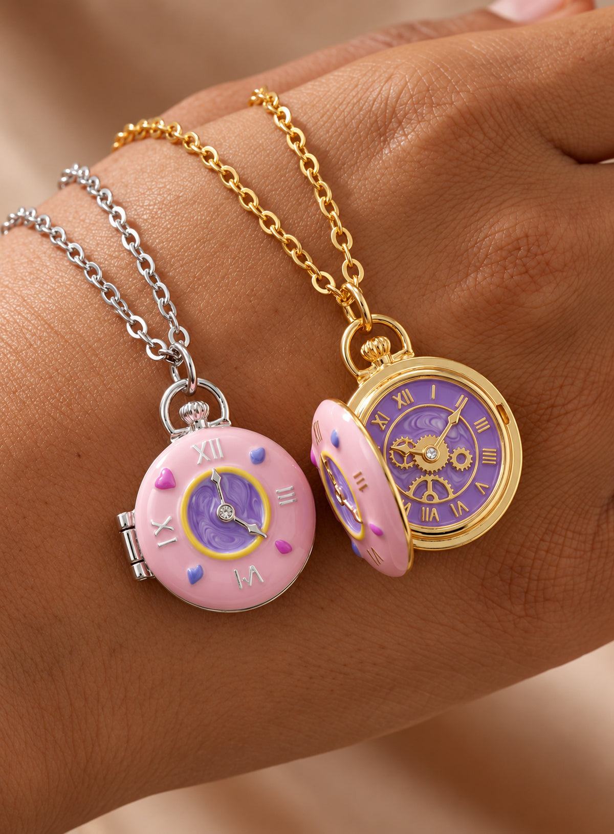 Round locket necklace with a pink enamel cover, purple clock motifs and small colored accents