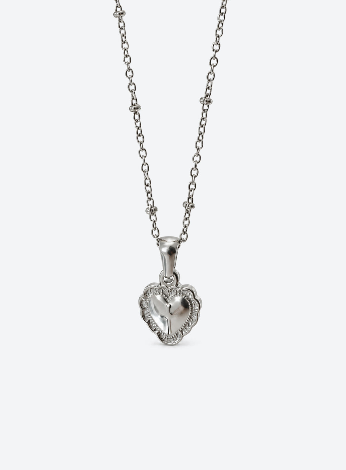 Silver-tone fine chain necklace with engraved heart pendant and raised reflective metal centre