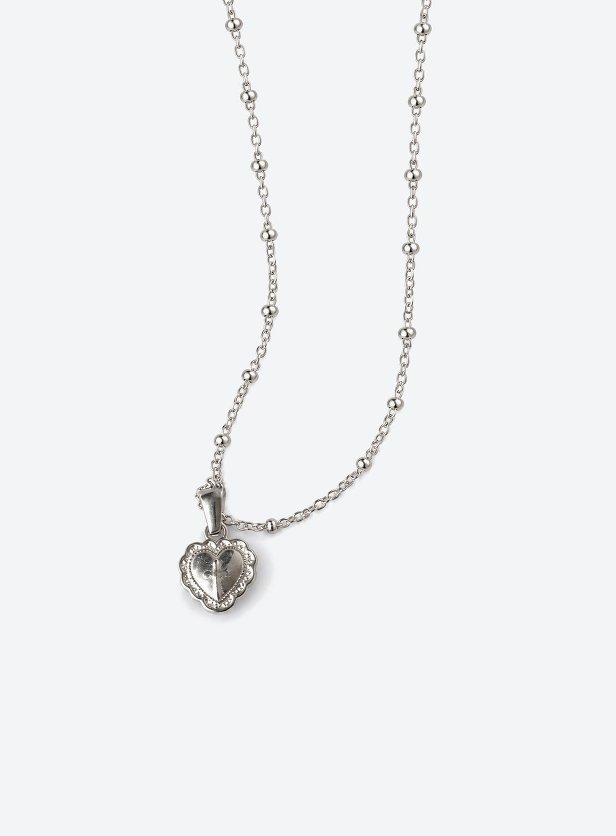 Silver-tone fine chain necklace with engraved heart pendant and raised reflective metal centre