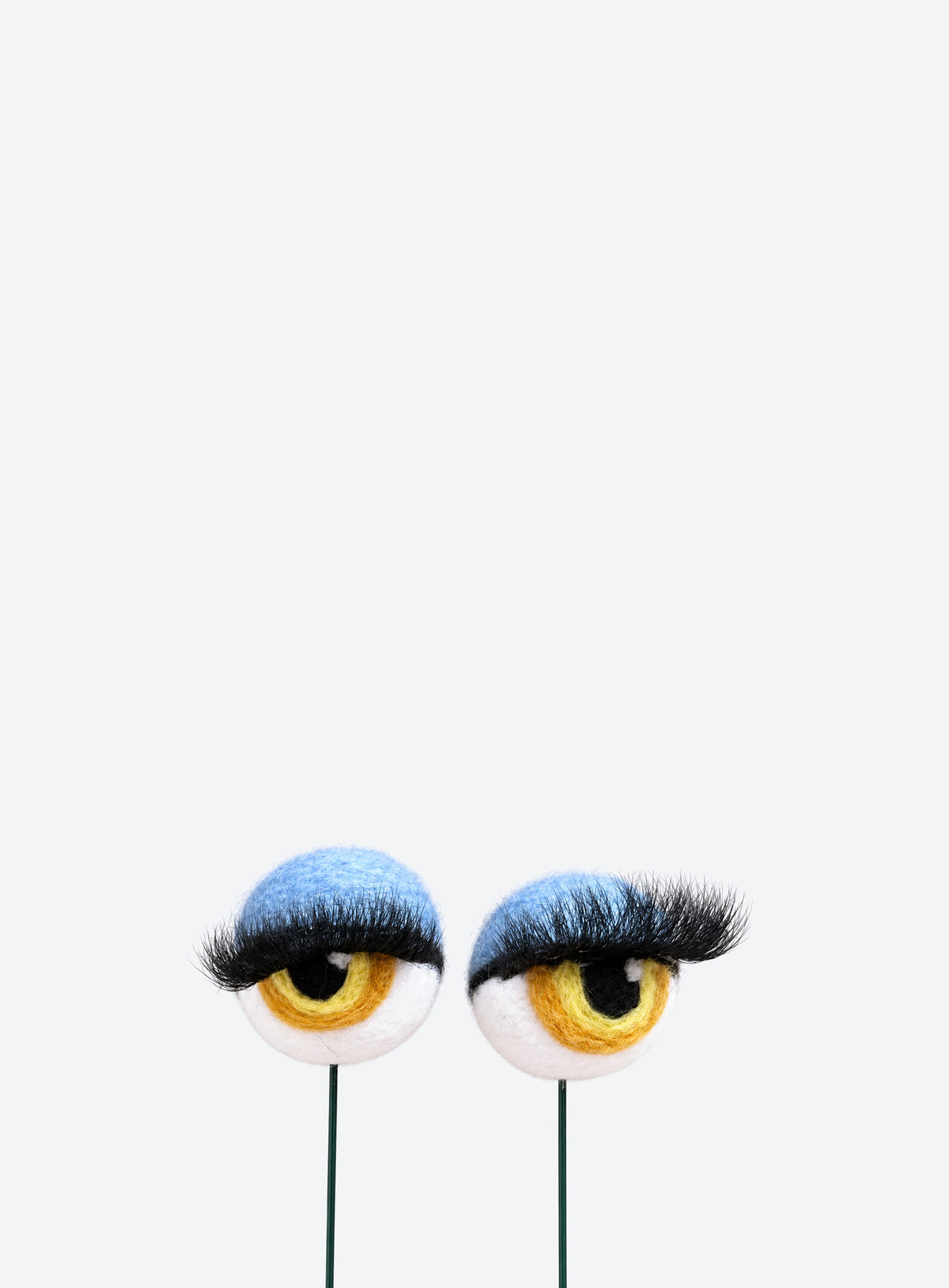 Felt eyeball plant stakes with colorful eyeshadow, eyelashes, and floral wire stems