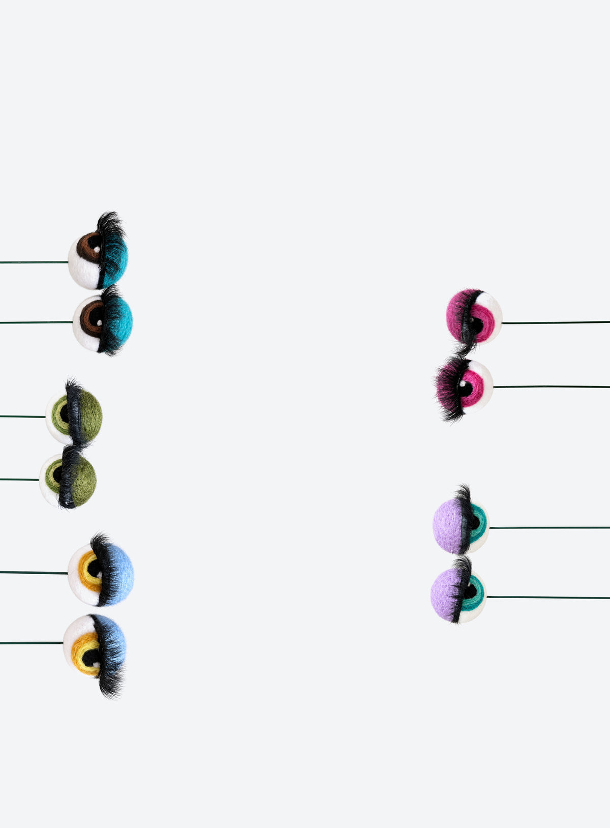 Felt eyeball plant stakes with colorful eyeshadow, eyelashes, and floral wire stems