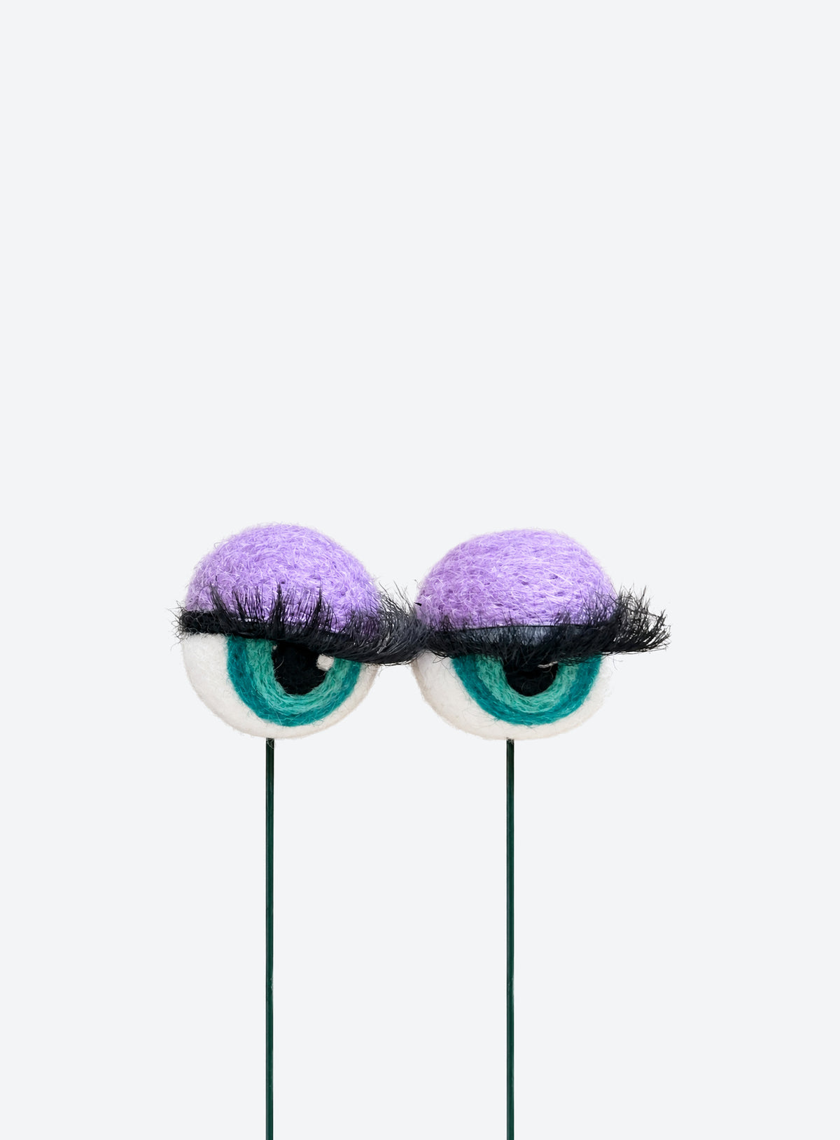 Felt eyeball plant stakes with colorful eyeshadow, eyelashes, and floral wire stems